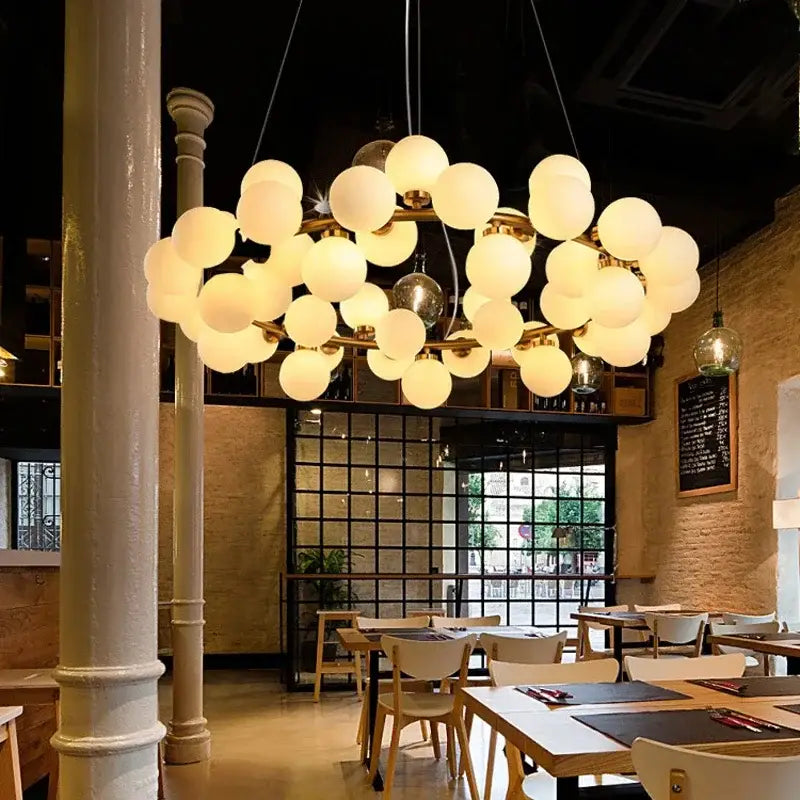 Modern gold glass ball led chandelier featuring frosted glass globe bulbs on brass frame for dining room decorbites glass ball