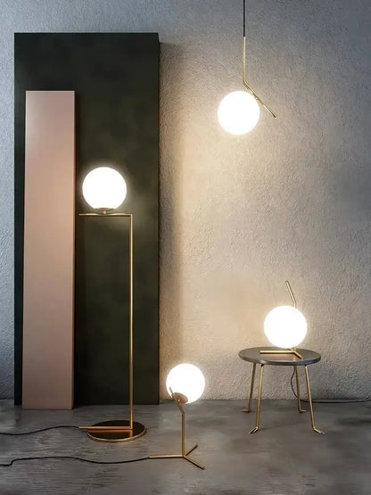 Modern gold glass ball led chandelier light with gold-toned minimalist table lamps featuring spherical frosted glass shades