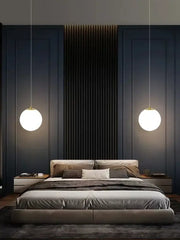 Modern gold glass ball led pendant chandelier with warm white glow and gold-toned decorbites glass ball fixtures above bed