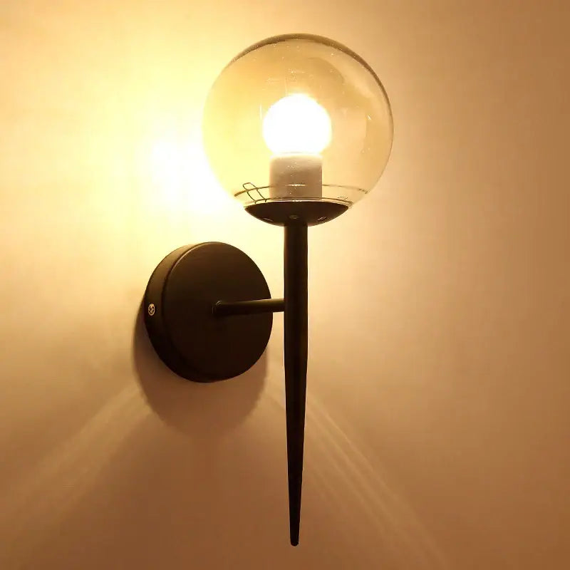 Modern gold glass ball led wall lights featuring a black metal sconce with a clear glass ball led for bedroom decorbites wall lights