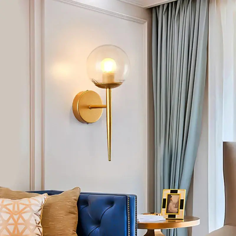 Modern gold glass ball led wall lights with clear glass globe and slender stem for bedroom passage decorbites wall lights