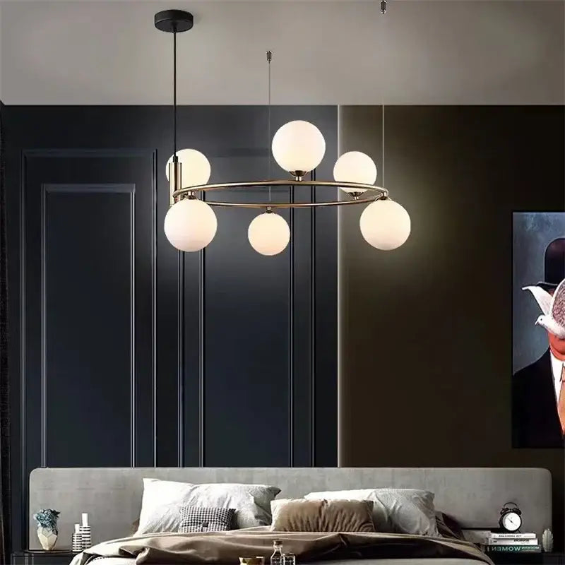 Modern brass-toned glass ball pendant chandelier with six frosted globe lights for dining room decorbites glass ball design