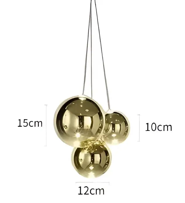 Modern gold glass ball pendant chandelier featuring a gold-toned spherical pendant light with reflective finish and hanging chains