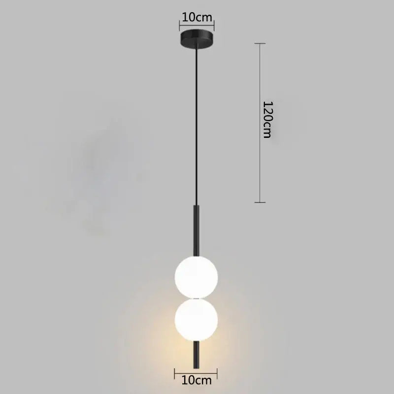 Minimalist black pendant light with two glowing white glass ball bulbs by decorbites for modern bedroom decor