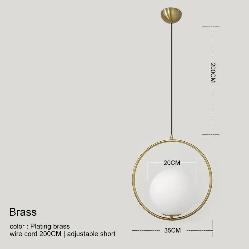 Modern gold glass ball pendant light featuring a brass frame and white glass globe suspended by adjustable wire cord