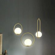 Three modern pendant lights with gold-toned metal frames and frosted glass spheres decorbites glass ball pendant fixture