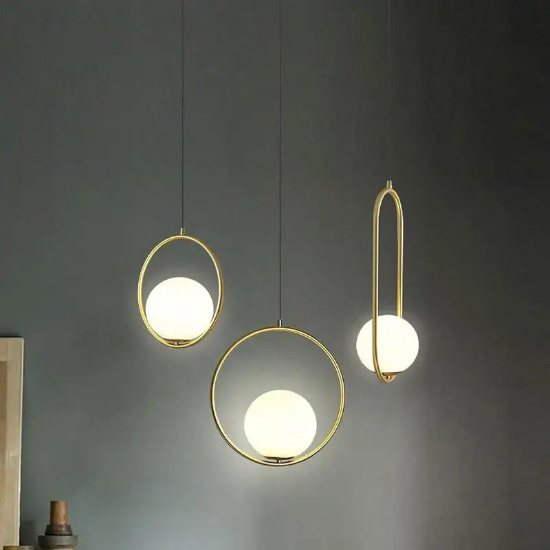Three modern pendant lights with gold-toned metal frames and frosted glass spheres decorbites glass ball pendant fixture
