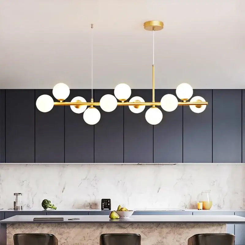 Modern gold glass ball pendant light with multiple white glass bulbs in a linear design for dining room decorbites chandelier