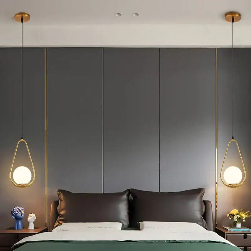 Modern gold glass ball pendant lights feature teardrop-shaped frosted glass globes for elegant dining room decorbites decor