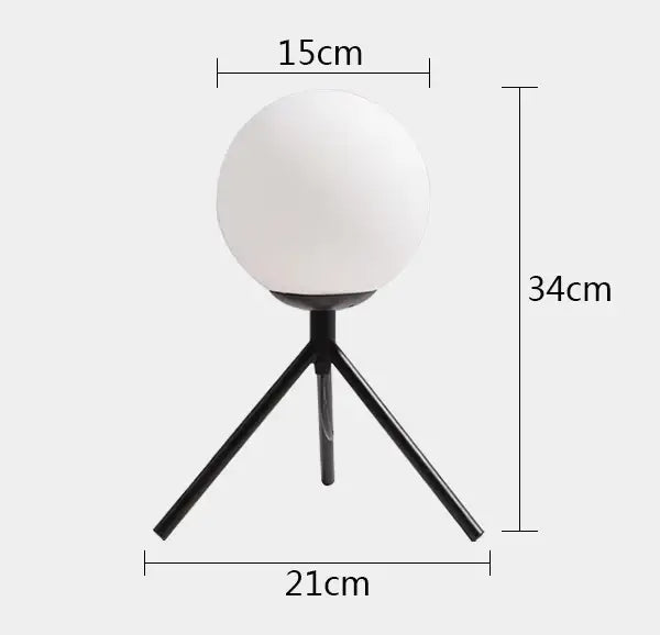 Modern gold glass ball table lamp with frosted globe light and black tripod base for stylish bedroom decorbites glass ball decor