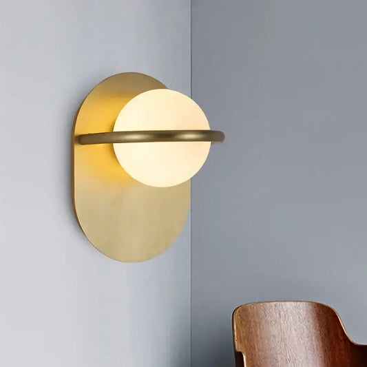 Modern gold glass ball wall light with a frosted glass globe and oval metal backplate for bedroom decorbites glass ball decor