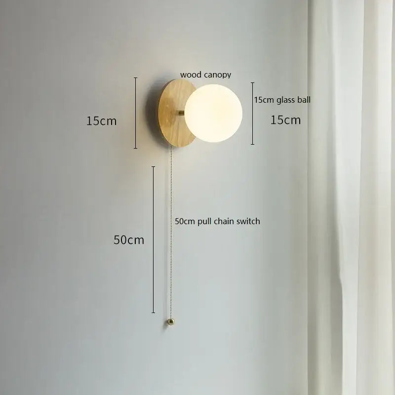 Minimalist wall lights with a warm-toned wood canopy and frosted decorbites glass ball featuring a 50cm pull chain