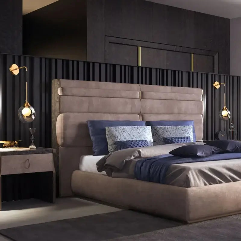 Modern gold glass ball wall sconce mounted near beige tufted bed with navy blue bedding for elegant bedroom lighting decorbites glass ball gold