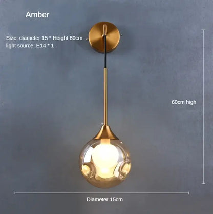 Modern gold glass ball wall sconce with brass mounting plate and amber spherical glass globe for bedroom lighting decorbites glass ball