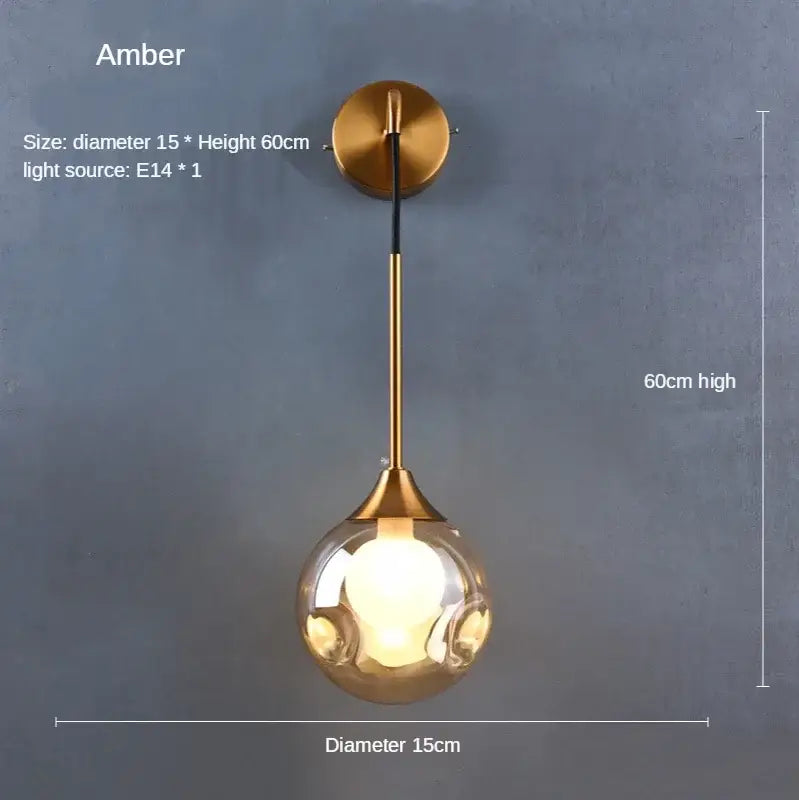 Modern gold glass ball wall sconce with brass mounting plate and amber spherical glass globe for bedroom lighting decorbites glass ball