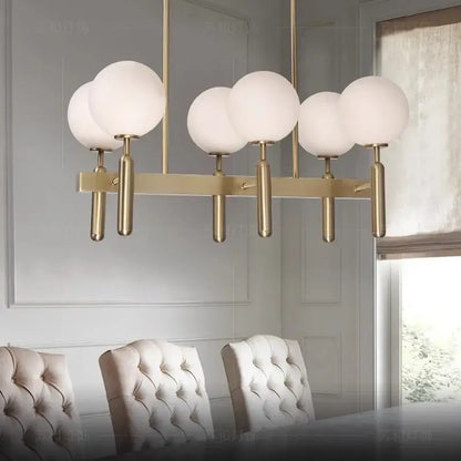 Modern gold glass balloon chandelier with five frosted glass globes on a sleek horizontal bar for dining room decorbites glass balloon
