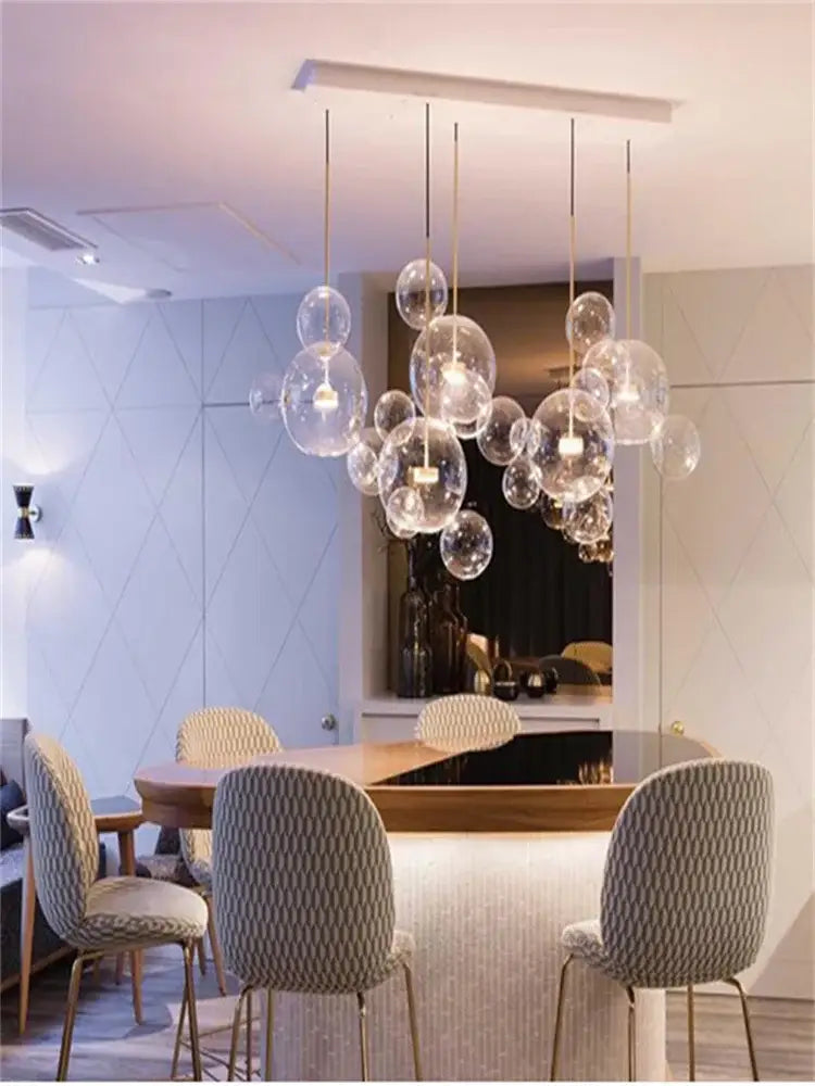 Modern gold decorbites glass bubble chandelier with clear spherical bulbs and thin rods for dining room lighting