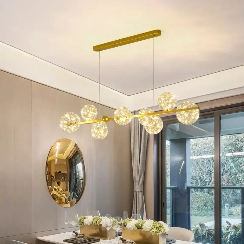 Modern gold glass bubble led chandelier with spherical glass globe lights suspended from sleek bar for dining room decorbites glass bubble