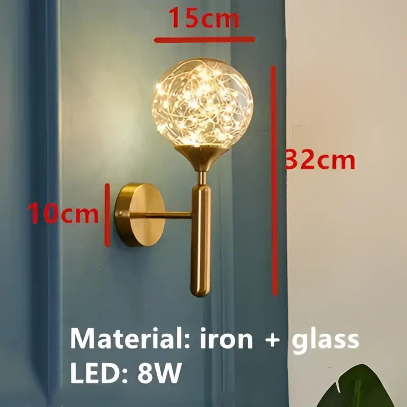 Modern gold glass bubble led chandelier featuring a gold-toned wall sconce with a glass globe filled with fairy lights decorbites glass bubble