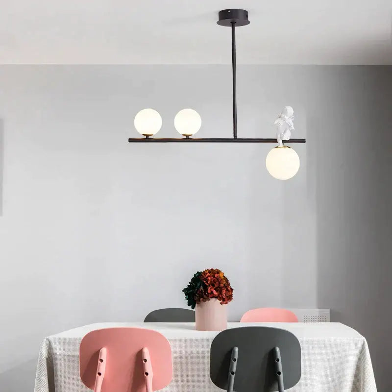 Modern black metal pendant light with three frosted glass globes and white figurine accent for decorbites glass bubble pendant