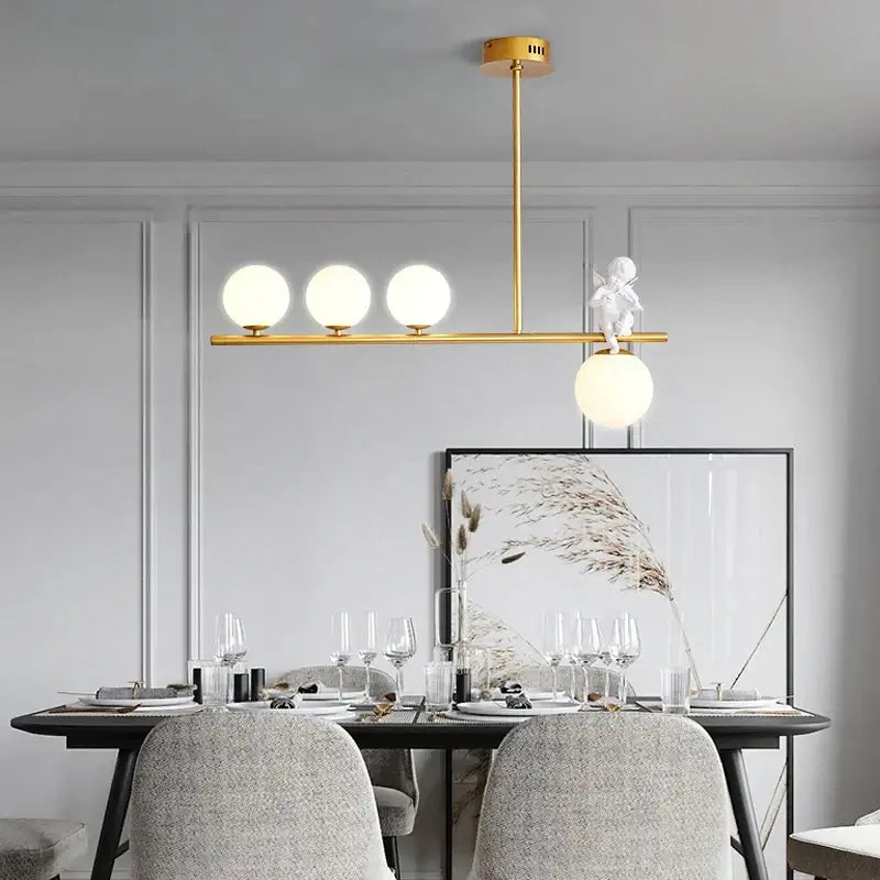 Modern gold glass bubble pendant light with three frosted bulbs and a white cherub decorbites glass bubble detail