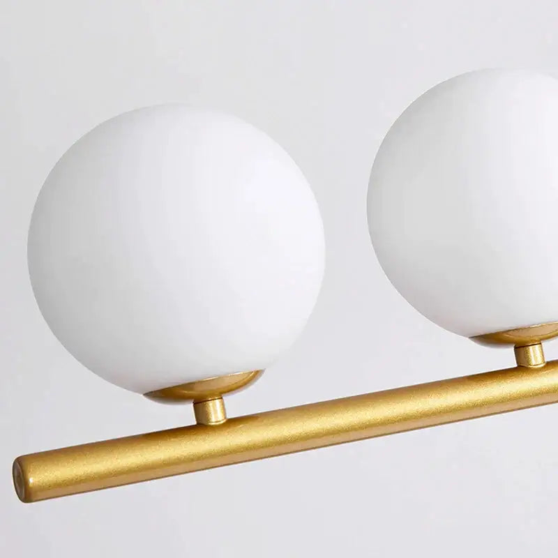 Modern gold glass bubble pendant light with frosted white glass bubble shades on brushed gold metal bar for dining room decorbites glass bubble pendant