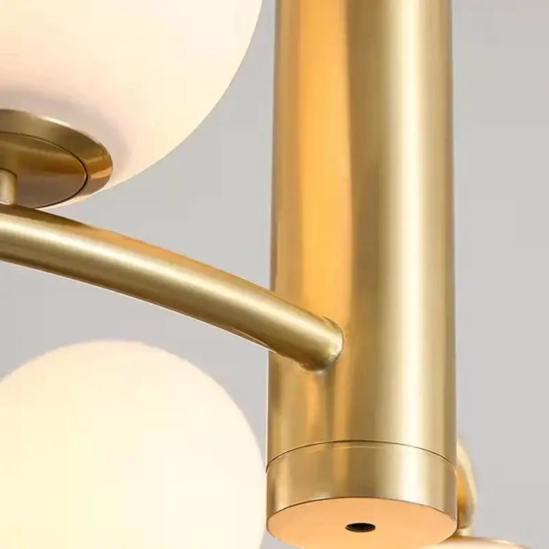 Modern gold glass chandelier g9 hanging light featuring a gold-toned cylindrical arm with polished metal finish and curved support bracket