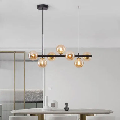 Modern black metal chandelier pendant light with warm amber glass globe bulbs and metal structure as focal point