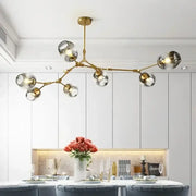 Modern gold glass led ceiling chandelier with multiple spherical glass shades for dining room lighting