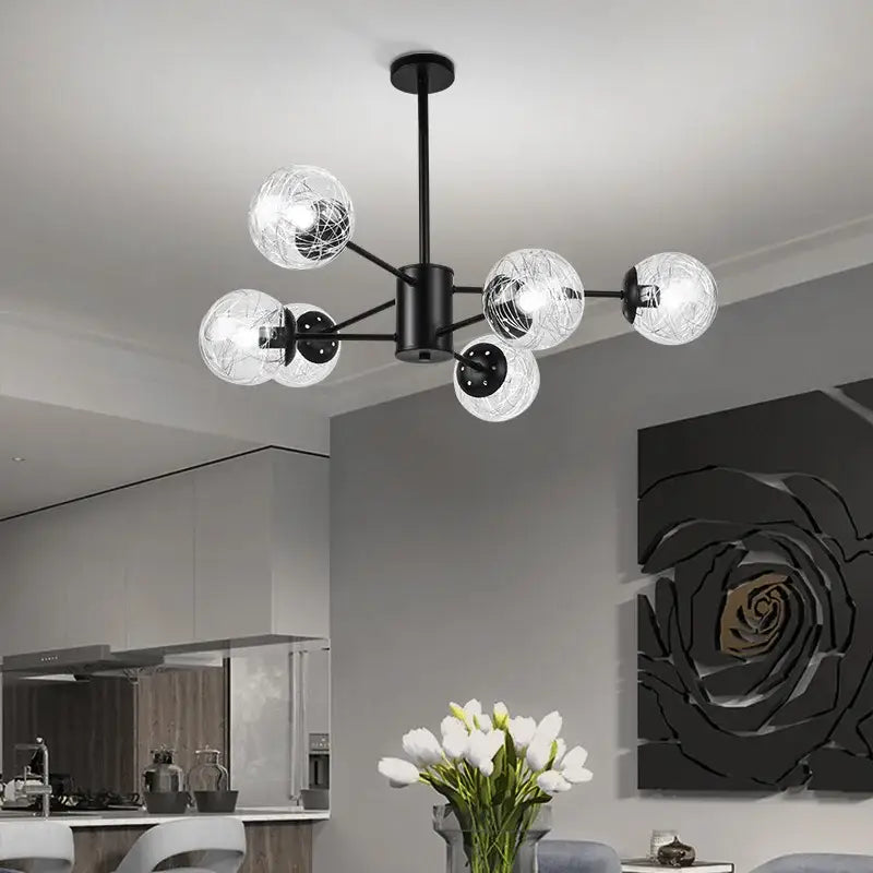 Black metal glass led chandelier with six clear globe shades and internal wireframe for modern dining room use
