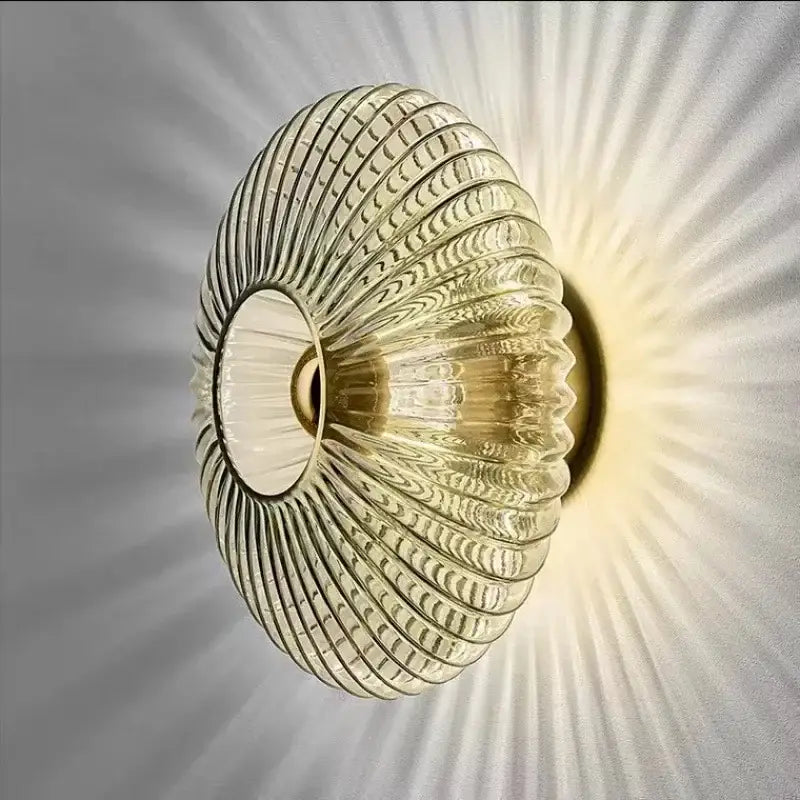 Modern gold glass ripple led wall lamp with translucent ribbed glass and warm radial light for bedroom decoration