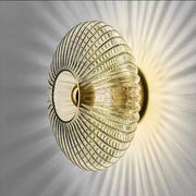 Modern gold glass ripple led wall lamps featuring a translucent ribbed glass sconce with a circular opening