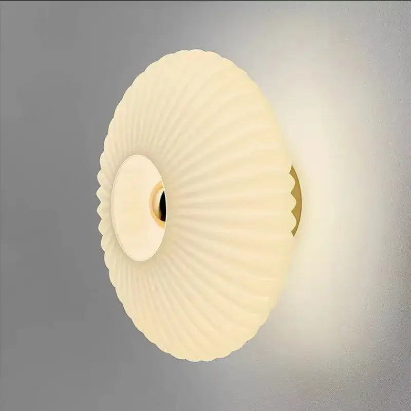 Cream-colored ribbed glass ripple led wall lamp with gold-toned mounting bracket for modern bedroom decoration