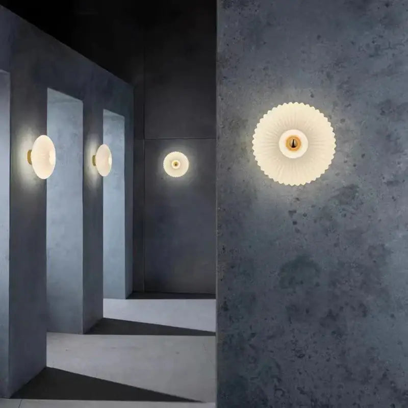 Cream-colored petal-shaped wall lamps with gold-toned center featuring modern glass ripple led design for bedroom decor