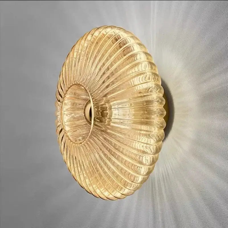 Modern gold glass ripple led wall lamp with ribbed translucent finish and concentric patterns for bedroom decor