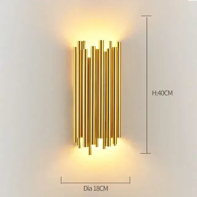 Modern gold wall sconce with vertical glass rod crystal design for bedroom lighting in a minimalist style