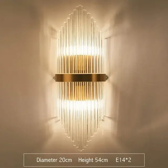 Modern gold wall sconce featuring clear glass rod crystal arranged in a vertical fan pattern for bedroom lighting