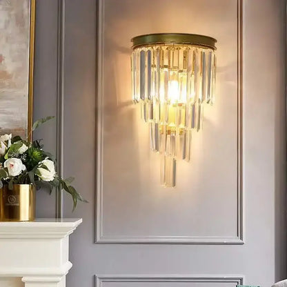 Modern gold wall sconce featuring cascading clear glass rod crystal rods ideal for bedroom lighting