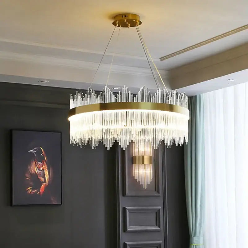 Modern gold pendant chandelier with a circular frame and cascading clear glass rod led crystals for dining room