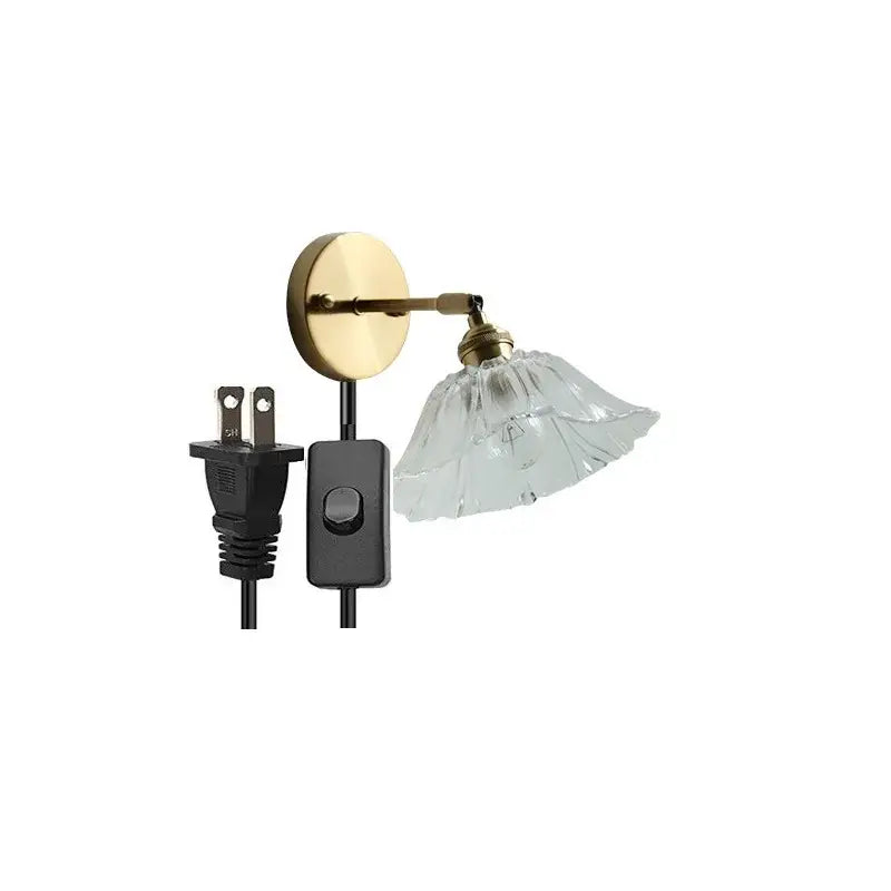 Modern gold wall light with brass finish glass shade and black power cord ideal as led wall reading lamp