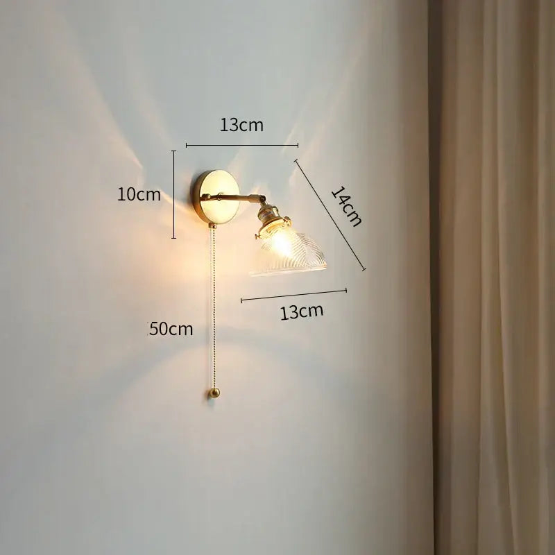 Modern gold glass shade wall light with vintage brass adjustable arm and clear textured glass shade for bedroom pull chain use