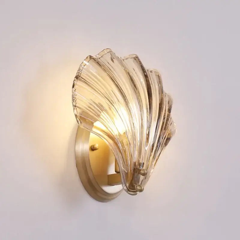 Modern gold glass shell led wall lamp with clear glass and brass-finished mounting base for bedroom use