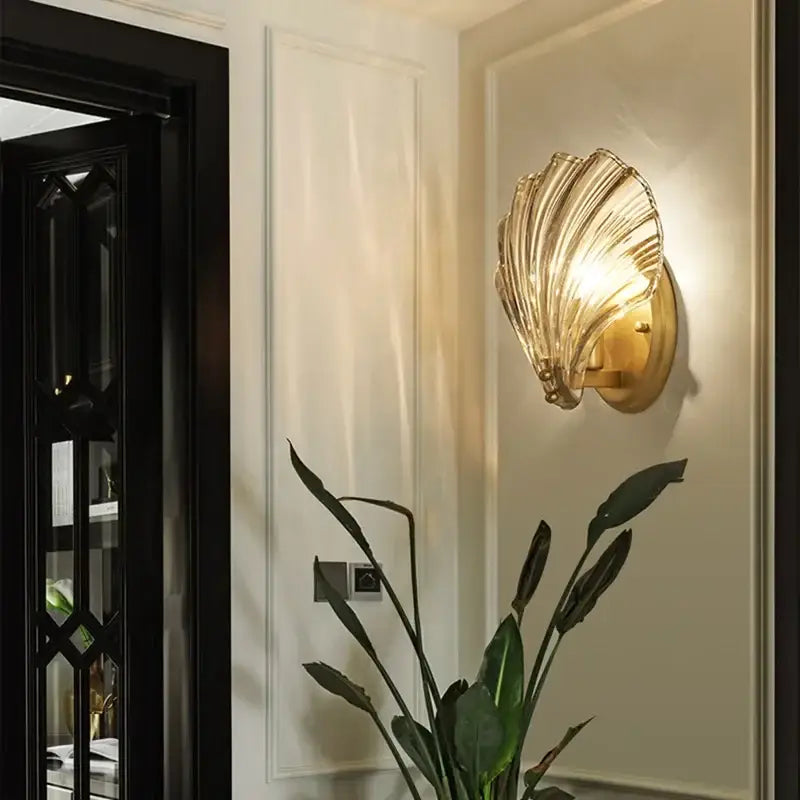 Modern gold glass shell led wall lamp with translucent ribbed glass finish designed as a bedroom wall sconce