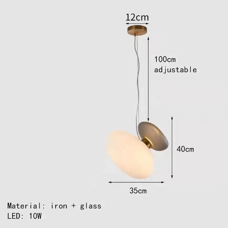 Modern gold and gray glass indoor pendant light with iron and brass finish providing warm glow for dining room decorbites glass indoor