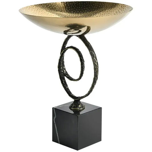 Modern gold hammered fruit bowl tray with twisted black metal stand on sleek black marble base for dining room use