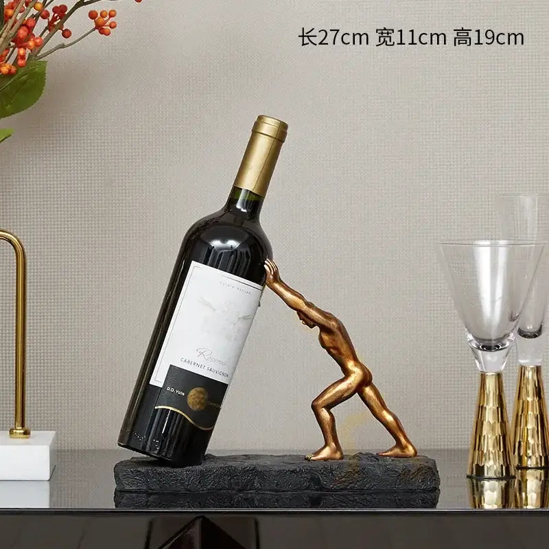 Modern gold hercules figurines wine rack with muscular man pushing dark glass bottle on textured black base decorbites hercules figurines wine