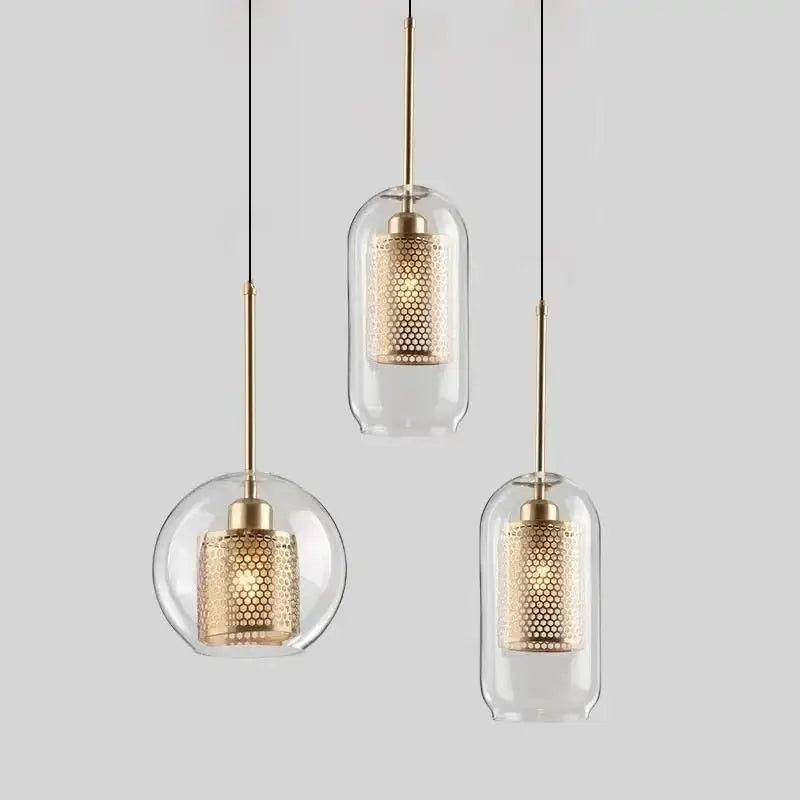 Modern gold honeycomb glass pendant lights feature clear glass pendant shades with gold-toned honeycomb interiors for dining rooms