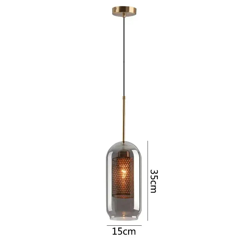 A modern gold glass pendant light with brass mount and amber honeycomb shade for dining room fixtures