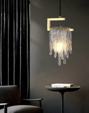 A modern gold icicle glass pendant light with a metal frame and cascading translucent shades for bedroom decorbites decor