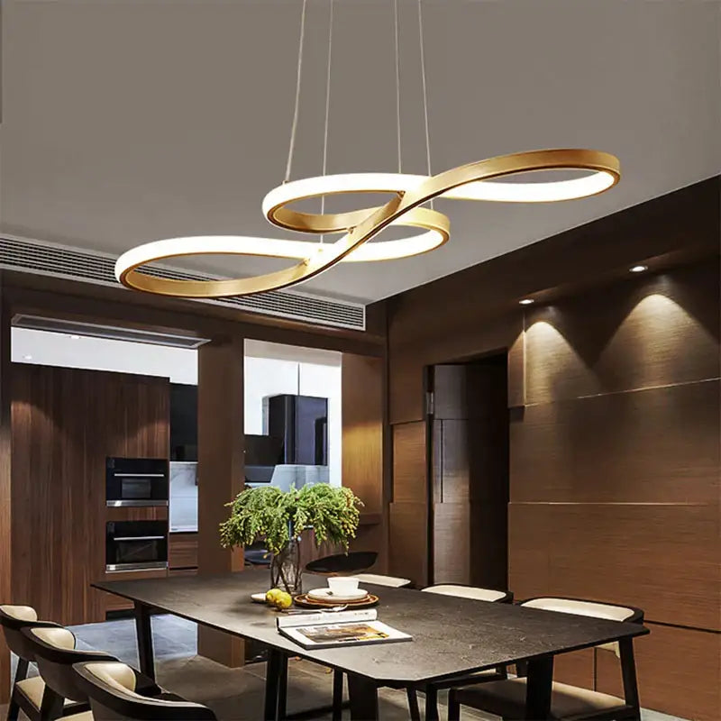 Modern gold infinity cord pendant light with brushed nickel accents for dining room featuring sleek design